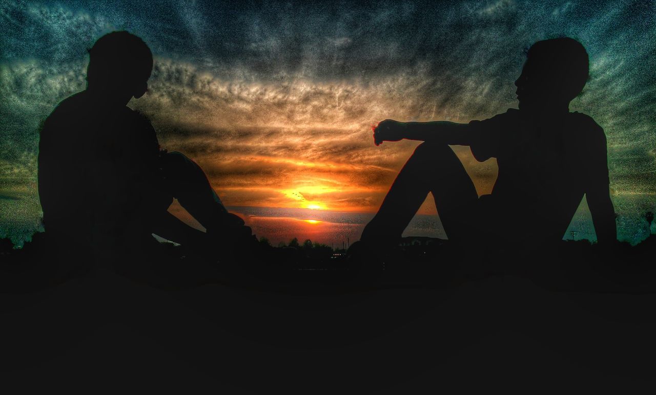 LOW ANGLE VIEW OF SILHOUETTE PEOPLE STANDING AGAINST SKY DURING SUNSET