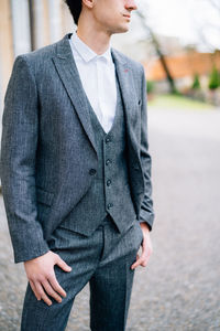 Midsection of man standing with umbrella