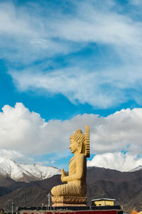 View of buddha statue against cloudy sky