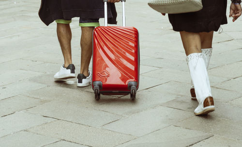 Low section of woman walking on footpath