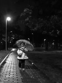 Boy wearing mask against sky at night