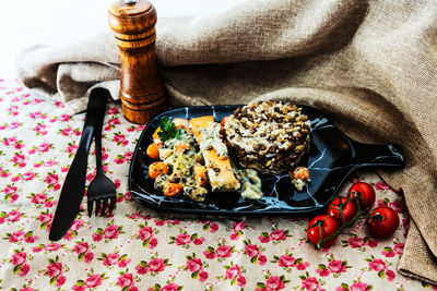 High angle view of meal on table with napkin and peppermill