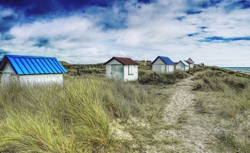 Houses on beach against sky