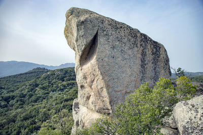 Low angle view of rock formation against sky