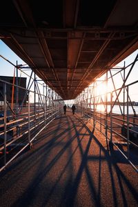 People on bridge against sky