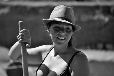 Close-up of young woman holding wood