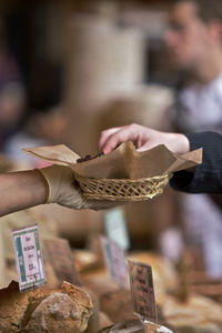 Man offering food to customer at store