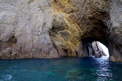 Scenic view of sea seen through cave