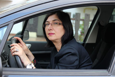 Portrait of woman sitting in car