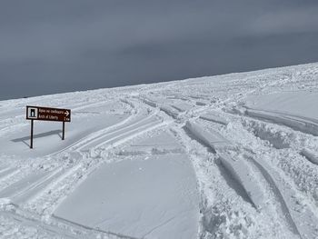 Aerial view of snow covered landscape against sky