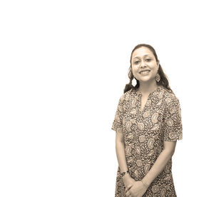 Portrait of a smiling young woman against white background