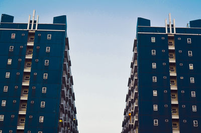 Low angle view of buildings against clear blue sky