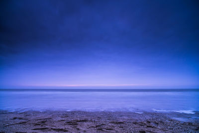 Scenic view of sea against blue sky