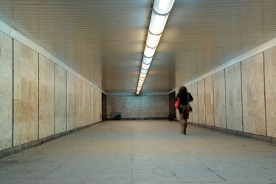 Rear view of woman walking in subway