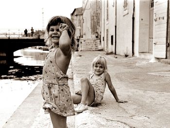 Portrait of smiling girls on steps by lake