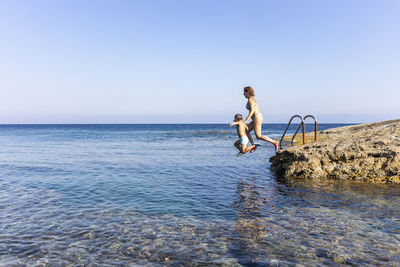 Full length of man against sea against clear sky