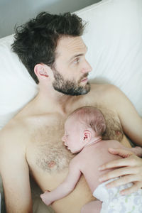 Mid adult man with newborn baby