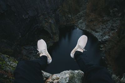 Low section of man standing on rock