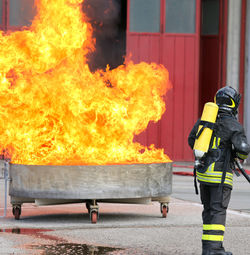 Firefighters' exercise with a tank full of flames and very hot fire and the fireman 