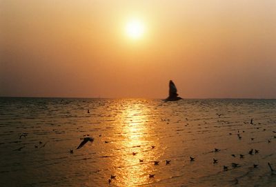 Scenic view of sea against orange sky