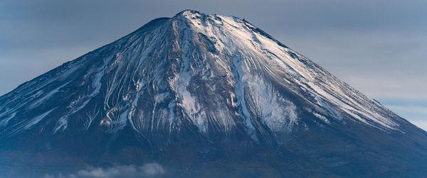 Low angle view of snowcapped mountain against sky