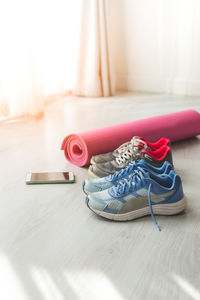 High angle view of shoes and exercise mat
