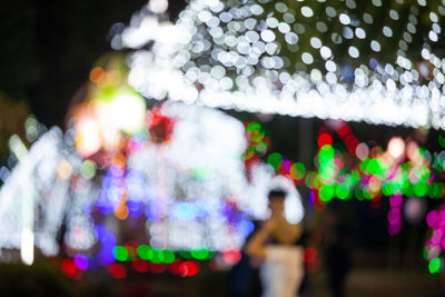 Defocused image of illuminated christmas tree at night