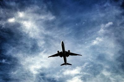 Low angle view of airplane flying in sky