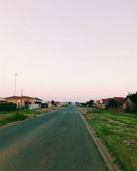 Empty road along trees