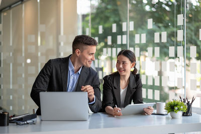 Happy business people talking in office