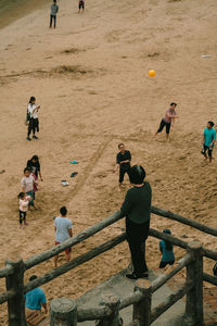 High angle view of people playing on sand