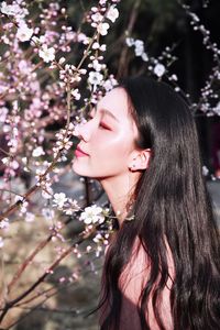 Close-up of woman smelling flowers