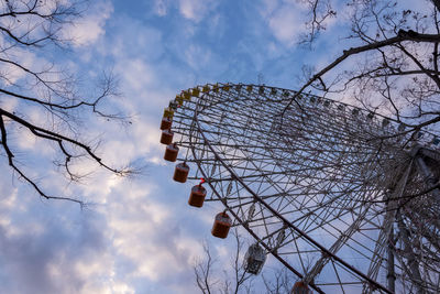 Low angle view of ferris wheel against sky