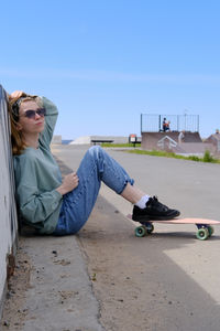 Young woman sitting on road
