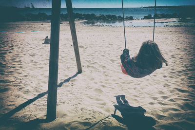 Person on swing in water