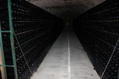 Wine bottles on rack at winery