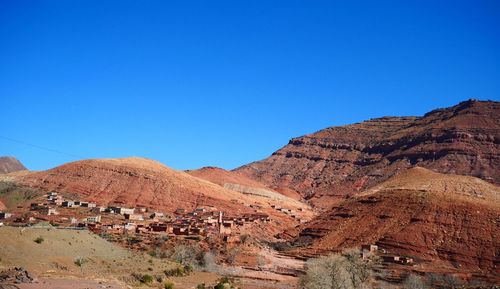 Scenic view of rocky mountains against clear blue sky