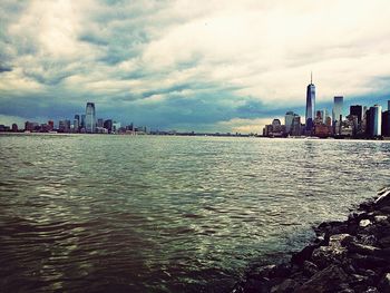 Cityscape against cloudy sky