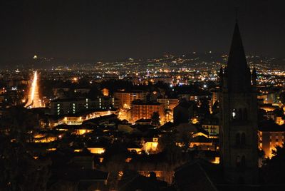 High angle view of city lit up at night