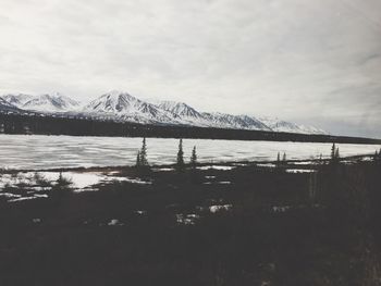 Scenic view of mountains against cloudy sky