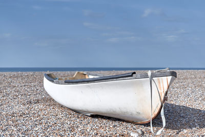 Lonely white boat on the beach in blurred background.