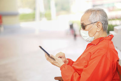 Low angle view of man using mobile phone