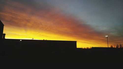 Silhouette of built structure at sunset