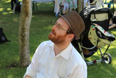 Mid adult man singing at park during purim