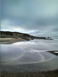 Scenic view of sea against cloudy sky