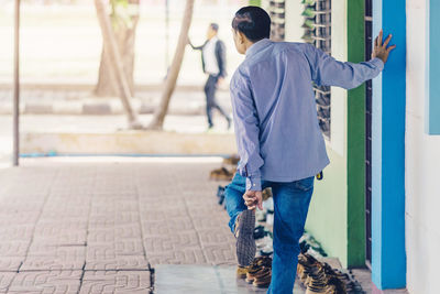 Rear view of men walking outdoors