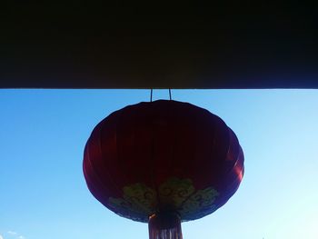 Low angle view of silhouette moon against blue sky