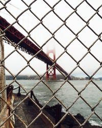 Close-up of chainlink fence at harbor