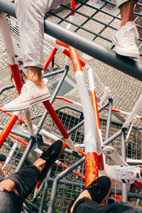 Low section of men on outdoor play equipment