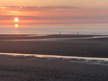 Scenic view of beach against sky during sunset